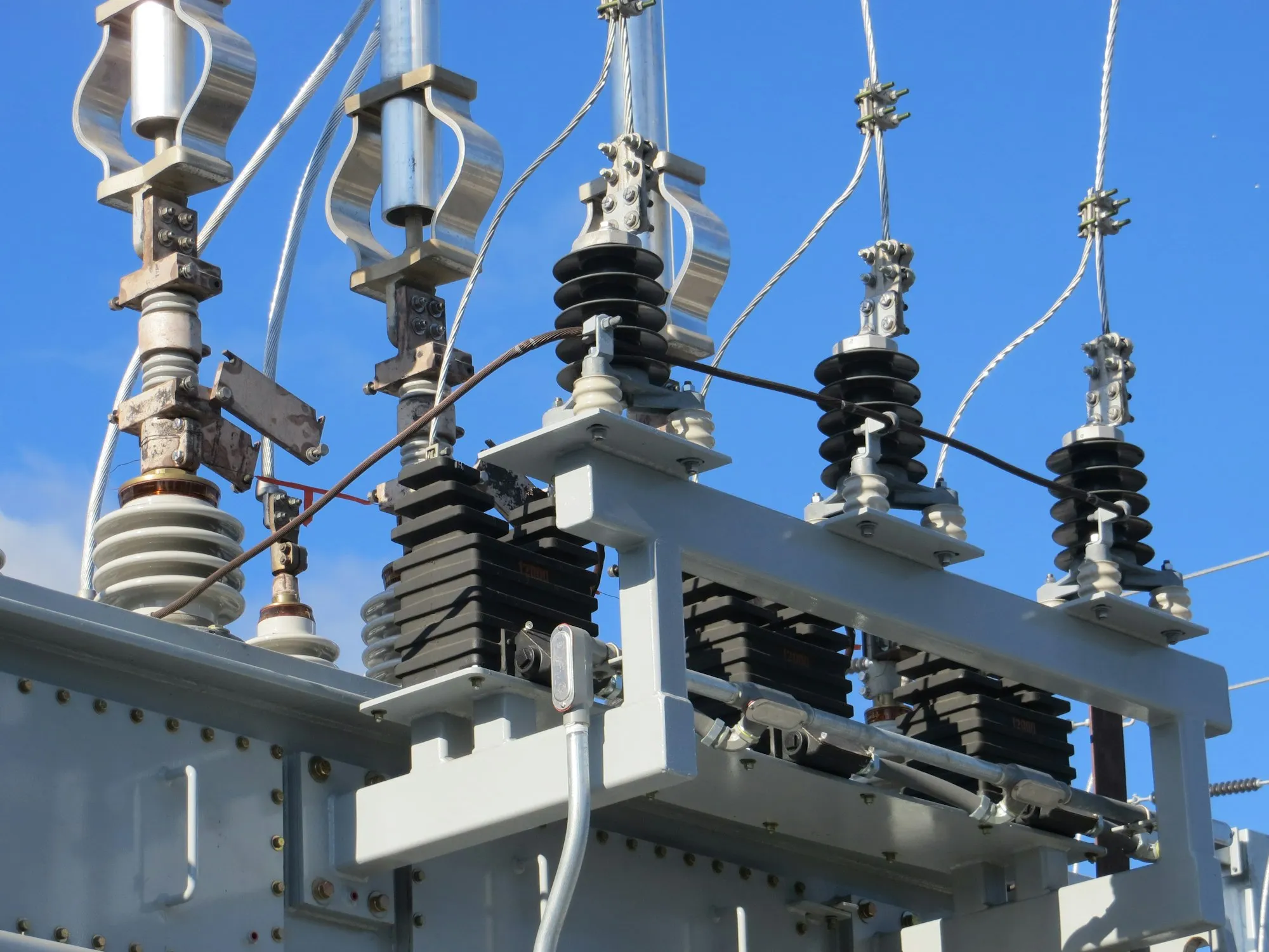 High-voltage transmission infrastructure, the physical layer that frequency regulation software must serve.